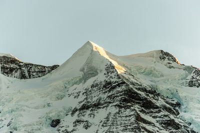 Scenic view of snowcapped mountains against clear sky