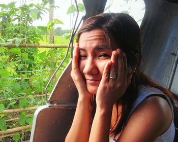 Close-up portrait of beautiful woman against trees