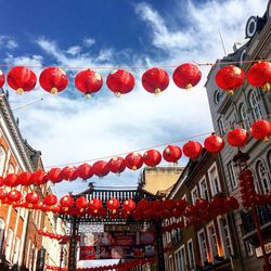 Low angle view of flags hanging against sky