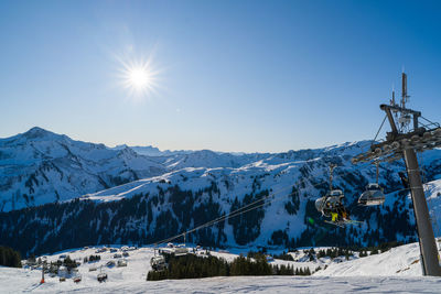 Scenic view of snowcapped mountains against blue sky