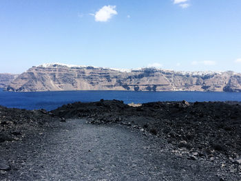 Scenic view of sea and mountains against sky