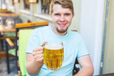Portrait of a young man drinking glass