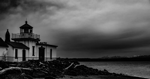 Traditional building by sea against sky