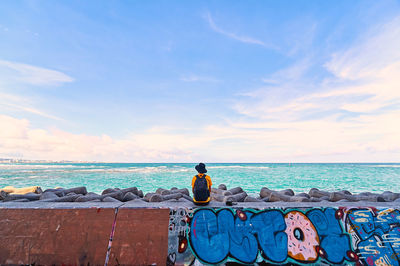 Man looking at sea against sky