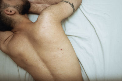 Midsection of man lying on bed