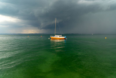 Sailboat on sea against sky