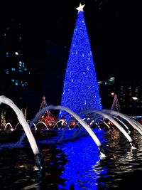 Illuminated christmas tree at night