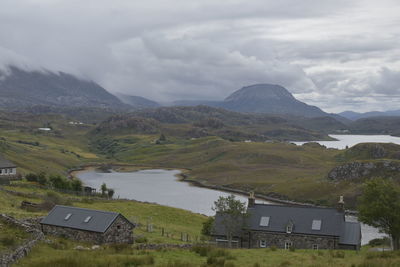 Scenic view of lake and mountains against sky