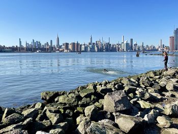 Panoramic view of sea and buildings against sky