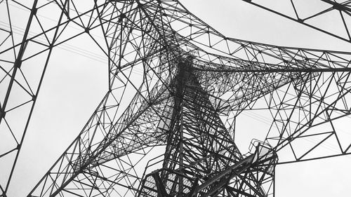 Low angle view of electricity pylon against sky