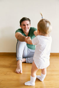 Full length of father and daughter at home