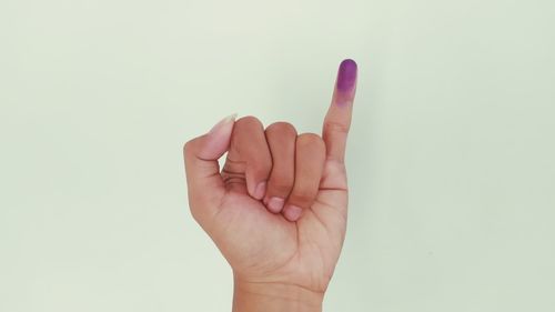 Close-up of human hand against white background