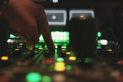 Cropped hand mixing music in recording studio