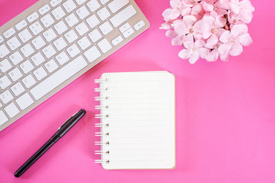 High angle view of pink flower on table