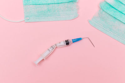 High angle view of dental equipment against pink background