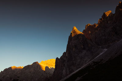 Last sunlight on dolomite walls and peaks at sunset, cima undici and cima una, south tyrol, italy