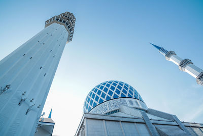 Low angle view of mosque buildings against blue sky