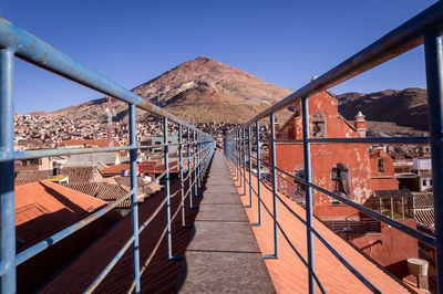 Footbridge against clear sky