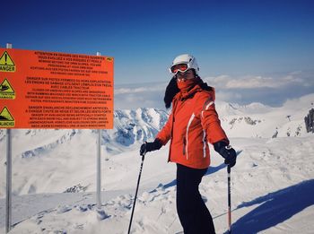 Woman skiing on snow covered landscape