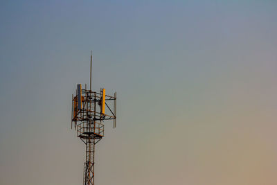 Low angle view of electricity pylon against clear sky