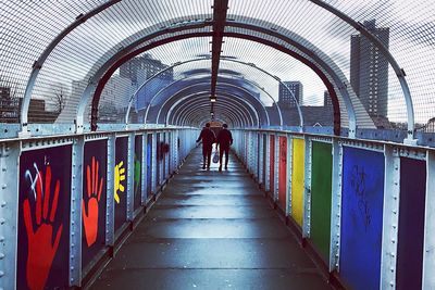 Rear view of man walking on corridor
