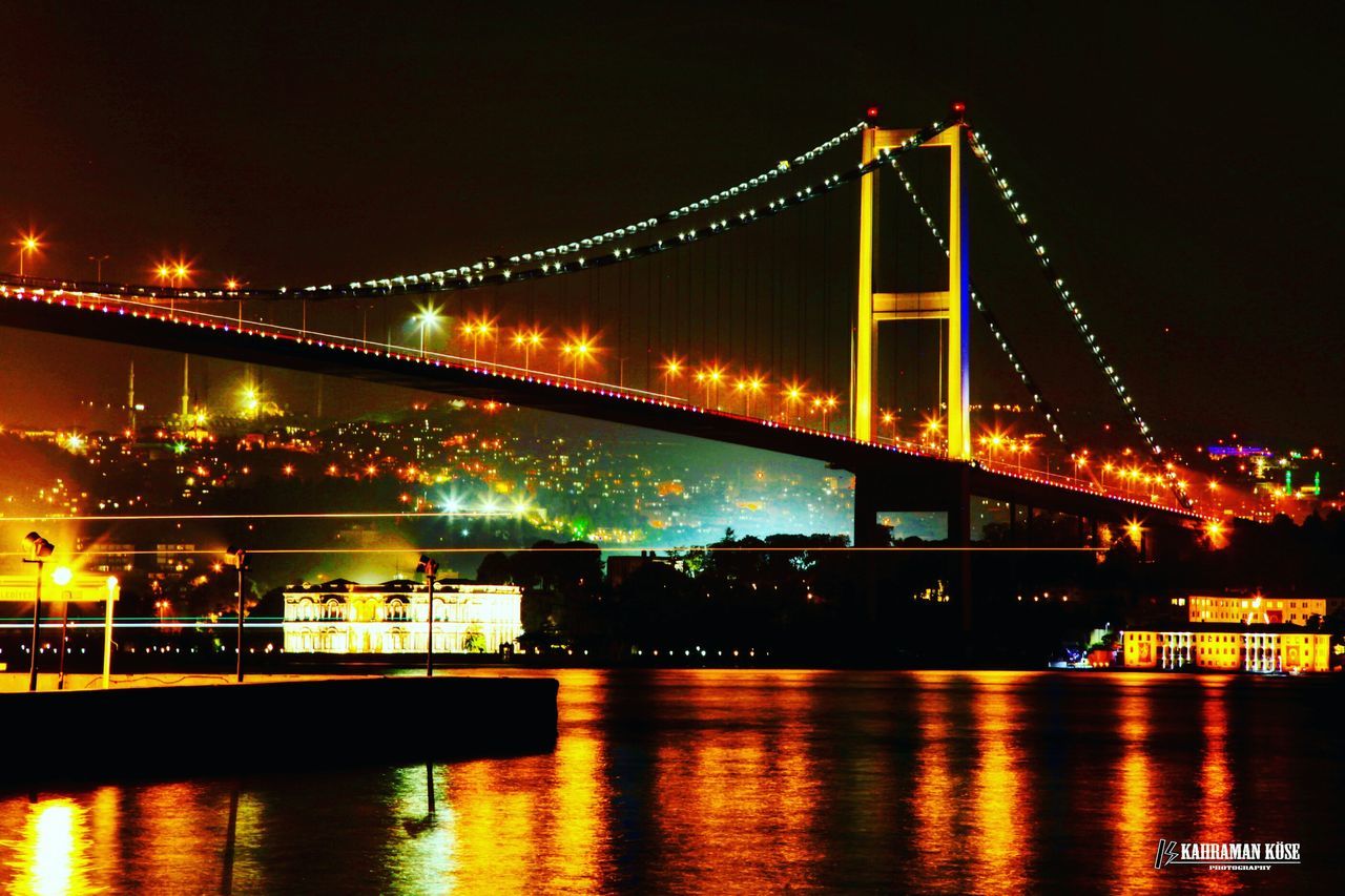 illuminated, night, water, waterfront, connection, bridge - man made structure, river, architecture, built structure, reflection, transportation, engineering, suspension bridge, city, bridge, sky, building exterior, nautical vessel, outdoors, travel destinations