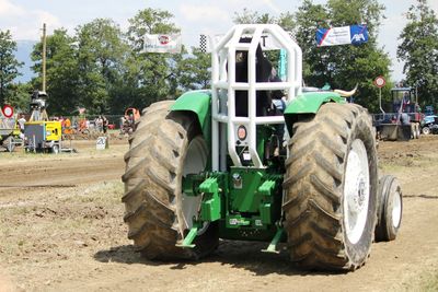 Man driving agricultural vehicle on field