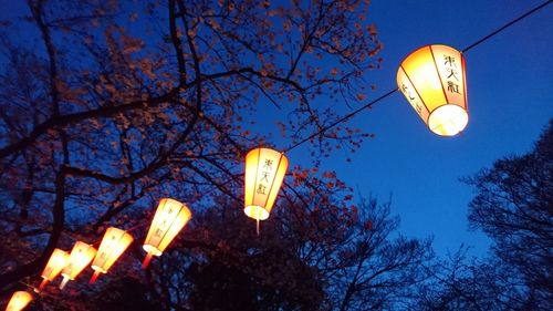 Low angle view of illuminated street light at night