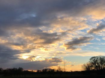 Low angle view of silhouette trees against sky during sunset