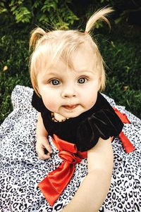 Portrait of cute girl sitting on grass