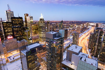 High angle view of illuminated city buildings against sky