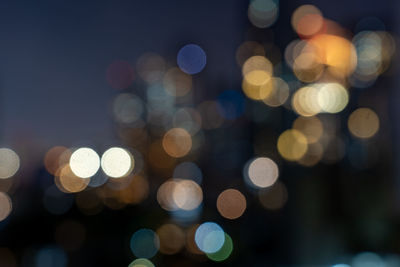 Defocused image of illuminated christmas lights at night