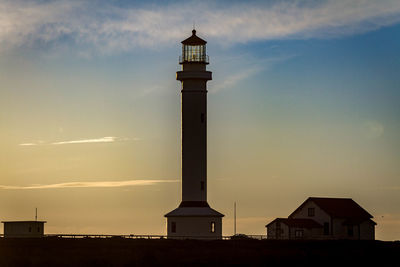 Low angle view of lighthouse against sky at sunset