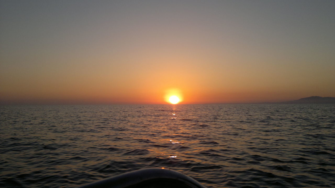 SCENIC VIEW OF SEA AGAINST ORANGE SKY