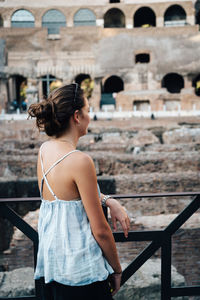 Woman standing in front of historical building