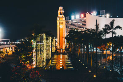 Illuminated buildings against sky at night