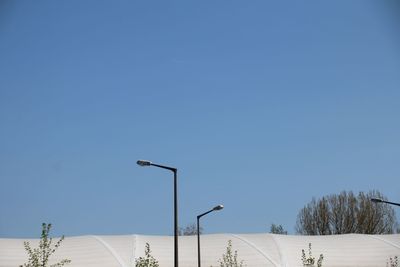 Low angle view of street light against clear blue sky