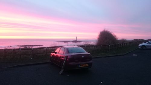 Car on road at sunset