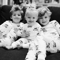 Portrait of siblings sitting on sofa