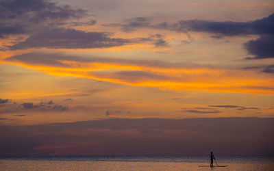 Scenic view of sea against orange sky