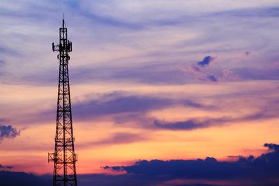 Low angle view of communications tower against sky during sunset