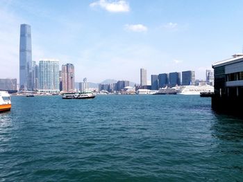 Scenic view of sea by buildings against sky