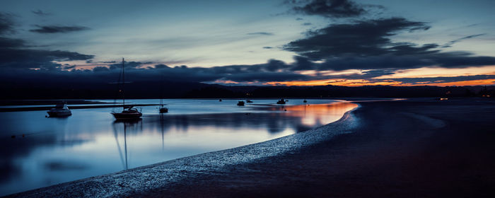 Scenic view of lake against sky at sunset