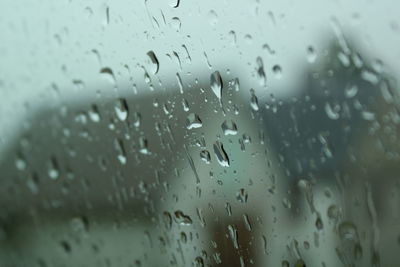 Full frame shot of wet glass window in rainy season