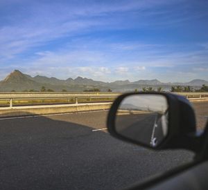 Close-up of car on road against sky