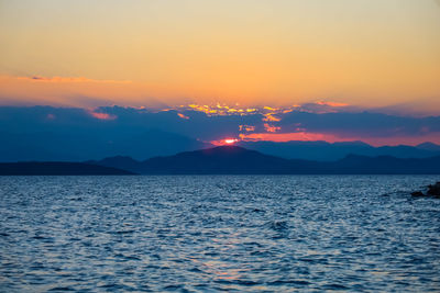 Scenic view of sea against romantic sky at sunset