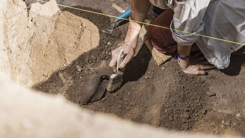 Archaeology - archaeologist revealing old ceramic object