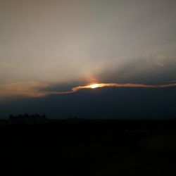 Silhouette of landscape against sky at sunset