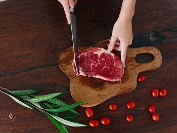 Cropped hand of person preparing food on table