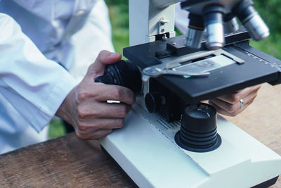 Midsection of man working on table